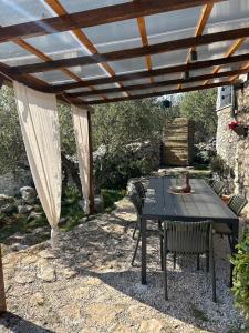 a picnic table under a wooden pergola at Mrdina house in Kali