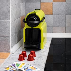 a yellow trash can sitting on a counter with red cones at Le Erbe Apartment tra Locali e vita Universitaria in Genoa