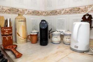 a kitchen counter with various appliances on a counter top at Casa da Castanha Sernancelhe in Sernancelhe