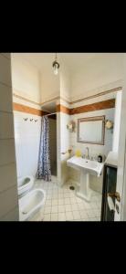 a bathroom with a sink and a toilet at Maison Artista in Procida