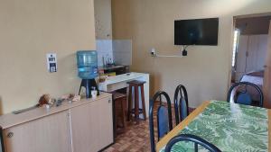 a kitchen with a table and a television on the wall at Depto Emma in Fiambalá