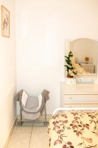 a bedroom with a bed and a chair next to a dresser at Casa da Castanha Sernancelhe in Sernancelhe