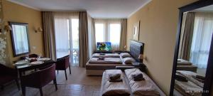 a bedroom with a bed and a desk and a mirror at Hotel Barceló Royal Beach in Sunny Beach