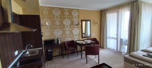 a living room with a kitchen and a dining room at Hotel Barceló Royal Beach in Sunny Beach