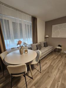 a living room with a couch and a table at Stadtoase Wels III in Wels +9 photos
