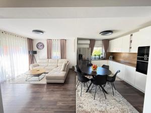 a kitchen and a living room with a table and chairs at Villa Marea in Nin