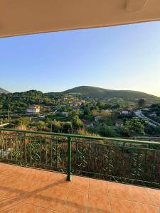 a balcony with a view of a city at Dimitris House in Pllakë
