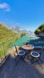 a table and chairs on a balcony with a view at Rifugio Capo D,acqua in Positano