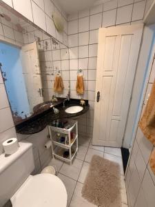 a bathroom with a toilet and a sink and a mirror at Natal Exclusive Pool Villa Private Community in Natal +11 photos