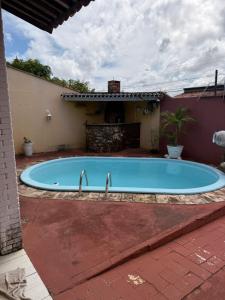a large swimming pool in the middle of a yard at Natal Exclusive Pool Villa Private Community in Natal