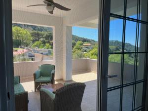 a porch with chairs and a table and a balcony at Casa Marina in Archipolis