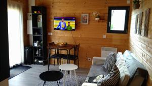 a living room with a couch and a table at L'Insolite in Melun