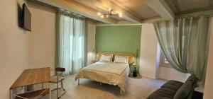a bedroom with a bed and a couch at HOUSE Sant'Angelo in Acquapendente