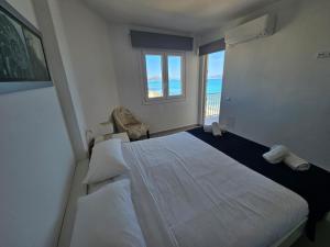 a bedroom with a large white bed and a window at Hawaii Beach Can Picafort in Can Picafort