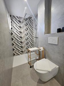 a bathroom with a white toilet and a shower at Hawaii Beach Can Picafort in Can Picafort +38 photos