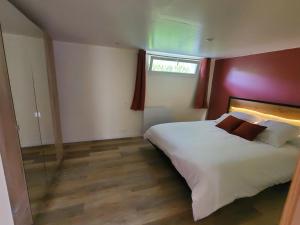 a bedroom with a white bed and a window at Appartement - Cestas in Cestas