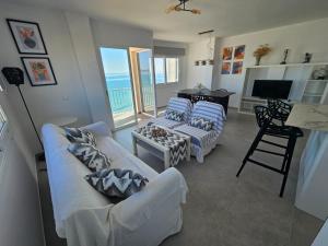 a living room with two white couches and a television at Hawaii Beach Can Picafort in Can Picafort