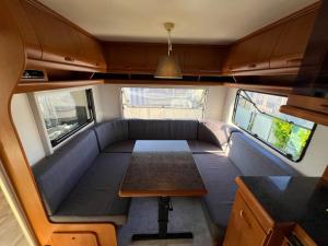 a small room with a couch and a table in it at Campingurlaub Sehlendorf in Blekendorf