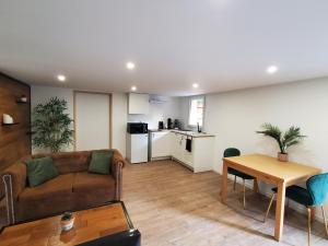 a living room with a couch and a table at Appartement - Cestas in Cestas