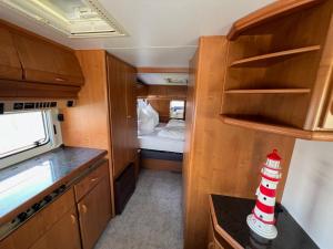 a small kitchen with a bed and a small room at Campingurlaub Sehlendorf in Blekendorf