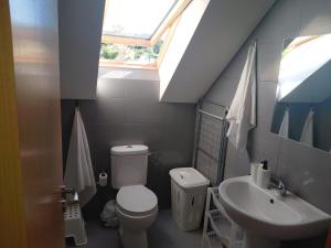 a bathroom with a toilet and a sink at Ático en Ribeira Ría de Arousa in Ribeira +33 photos
