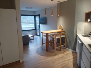 a kitchen and dining room with a table and chairs at Panorama Aparts Chalten in El Chalten +63 photos
