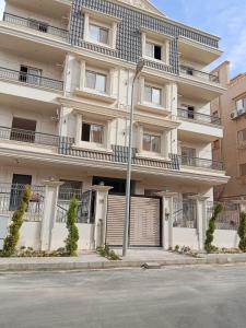 a building with a street light in front of it at Cozy Studio Apartment in Sheikh Zayed in Sheikh Zayed