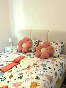 a bed with a floral bedspread with pillows on it at Jefimija Apartman Sokobanja in Soko Banja
