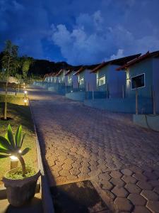 a cobblestone street in front of a row of houses at Pousada real chalés in Belo Vale +6 photos
