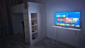 a white cabinet with a tv in a room at Modern Family Apartment, Free Parking, Balcony, Sleeps 5 in Bucharest