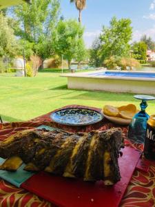 a table with a plate of food on it at Bungalow con alberca Privada y Climatizada en Tequisquiapan in Tequisquiapan