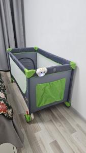 a toy bed in a corner of a room at Modern Family Apartment, Free Parking, Balcony, Sleeps 5 in Bucharest