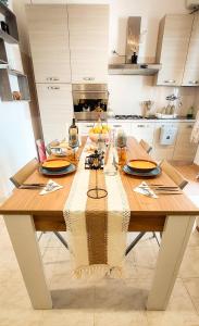 a wooden table in a kitchen with a dining room at Villa Mare Presepe in Torchiarolo