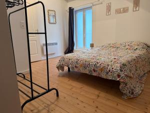a bedroom with a bed and a mirror in it at Maisonnette du Prieuré in Saint-Gilles