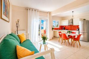 a living room with a green couch and a kitchen at 4 Seasons villa-Sea view in Hersonissos +41 photos