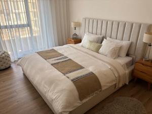 a bedroom with a large bed with a large window at Carrousel Atlantic View in Rabat +25 photos
