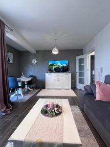 a living room with a couch and a table at Adagio Apartmani in Vrnjačka Banja