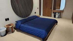 a bedroom with a blue bed and a mirror at Chic apartment in Aldea Mayab with Lagoon access and private splash pool in Xul-Ha +79 photos