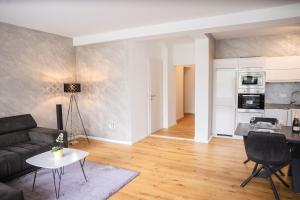 a living room with a couch and a table at Lakeside Diamond Apartment - Krumpendorf in Krumpendorf am Wörthersee