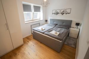 a bedroom with a bed with two pillows on it at Lakeside Diamond Apartment - Krumpendorf in Krumpendorf am Wörthersee