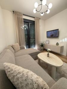 a living room with a couch and a table at CENTRAL SQUARE Tuzla in Tuzla