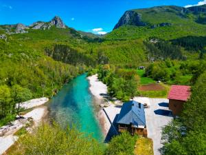 an aerial view of a river with mountains in the background at Modra Rijeka Resort in Glavatičevo