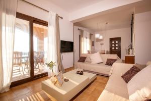 a living room with a couch and a table at Sonias Point of View in Myrties