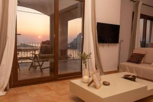 a living room with a view of a balcony at Sonias Point of View in Myrties