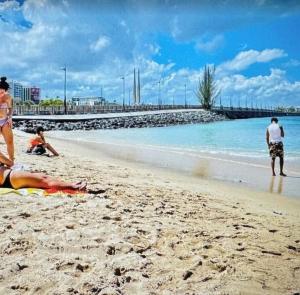 a group of people laying on the beach at Star of the Olympus 4a Standard Studio at Miramar Puerto Rico near beaches and Convention Center in San Juan