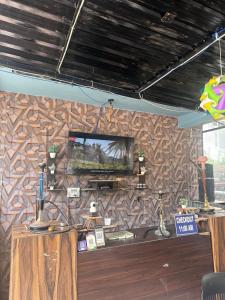 a room with a wall with a tv on it at Breathe Inn in Kasol