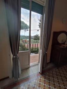 a door leading to a balcony with a view at Il Veliero in Bonassola