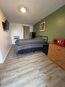 a bedroom with a bed and a wooden floor at Rivers Inn in Fort Madison
