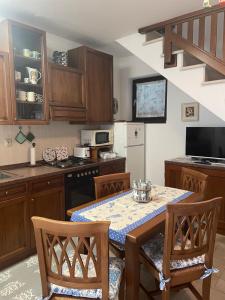 a kitchen with a table and chairs and a kitchen with at Phoenix in Peroj