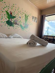 a bedroom with a bed with a towel on it at Aracari Stay in Quepos